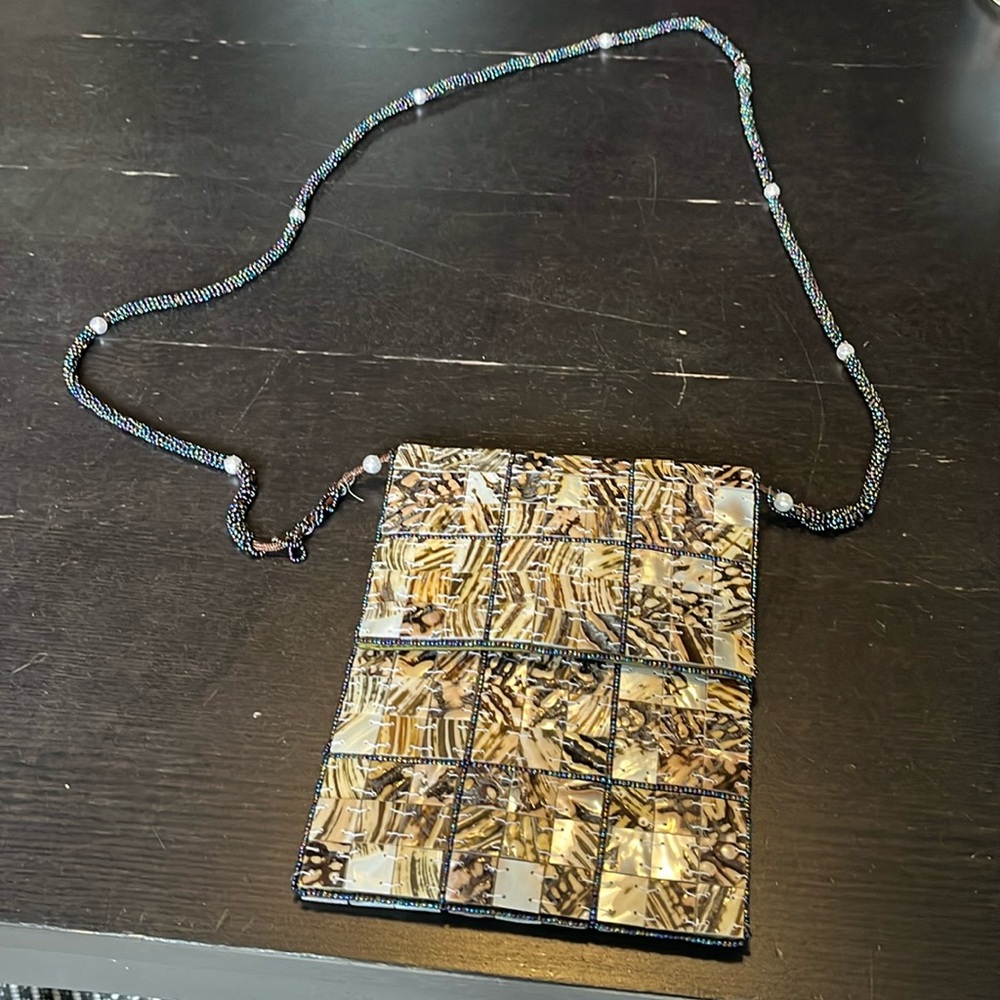 Mod by Design mother of pearl purse with green satin lining. Beaded strap.